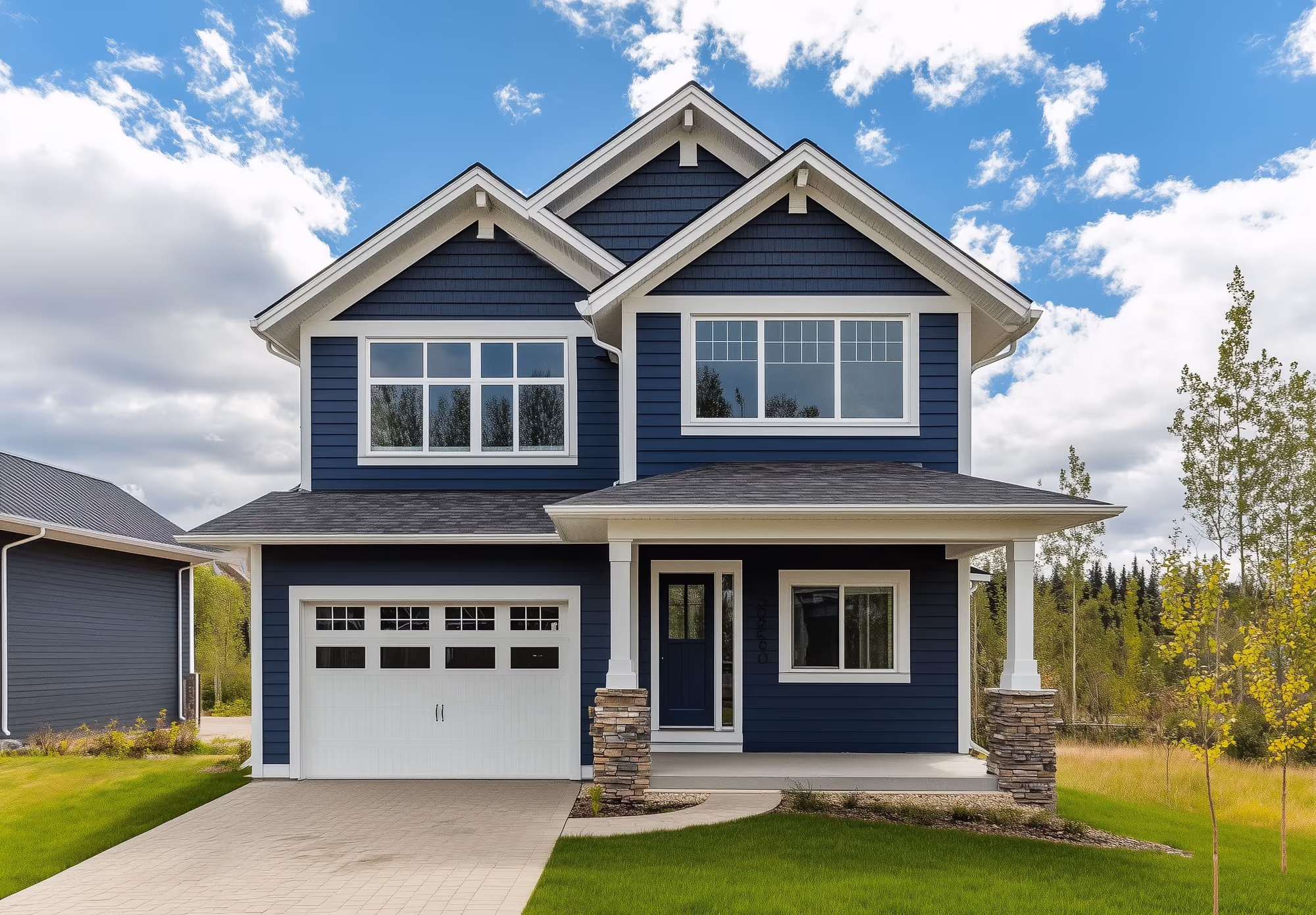 Two-story home with freshly painted dark blue siding and white trim